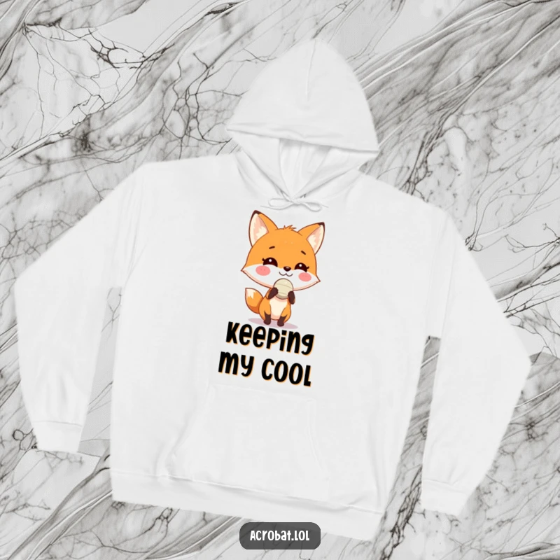Funny fox hoodie showcasing a playful fox with a grin skillfully balancing a tiny ball on its nose, offering humorous comfort.